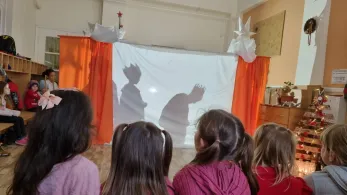 Children watching a play with other children in costume.