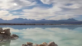Lagoon with mountains and blue sky with clouds. 