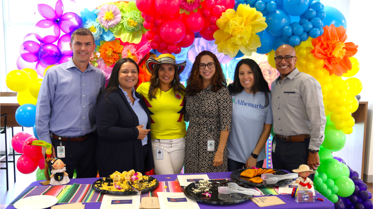 employees smiling at table 