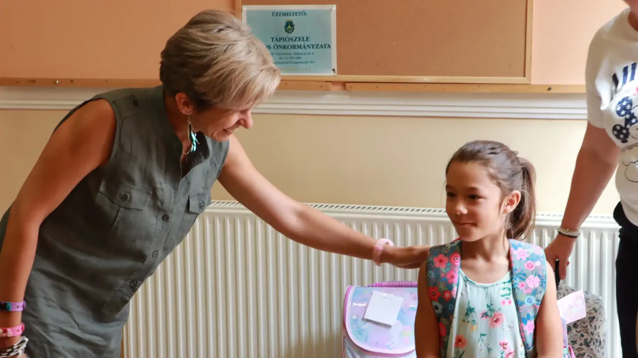Woman patting child on the back. 