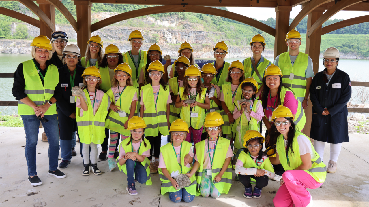 group of young students and Albemarle employees in hardhats