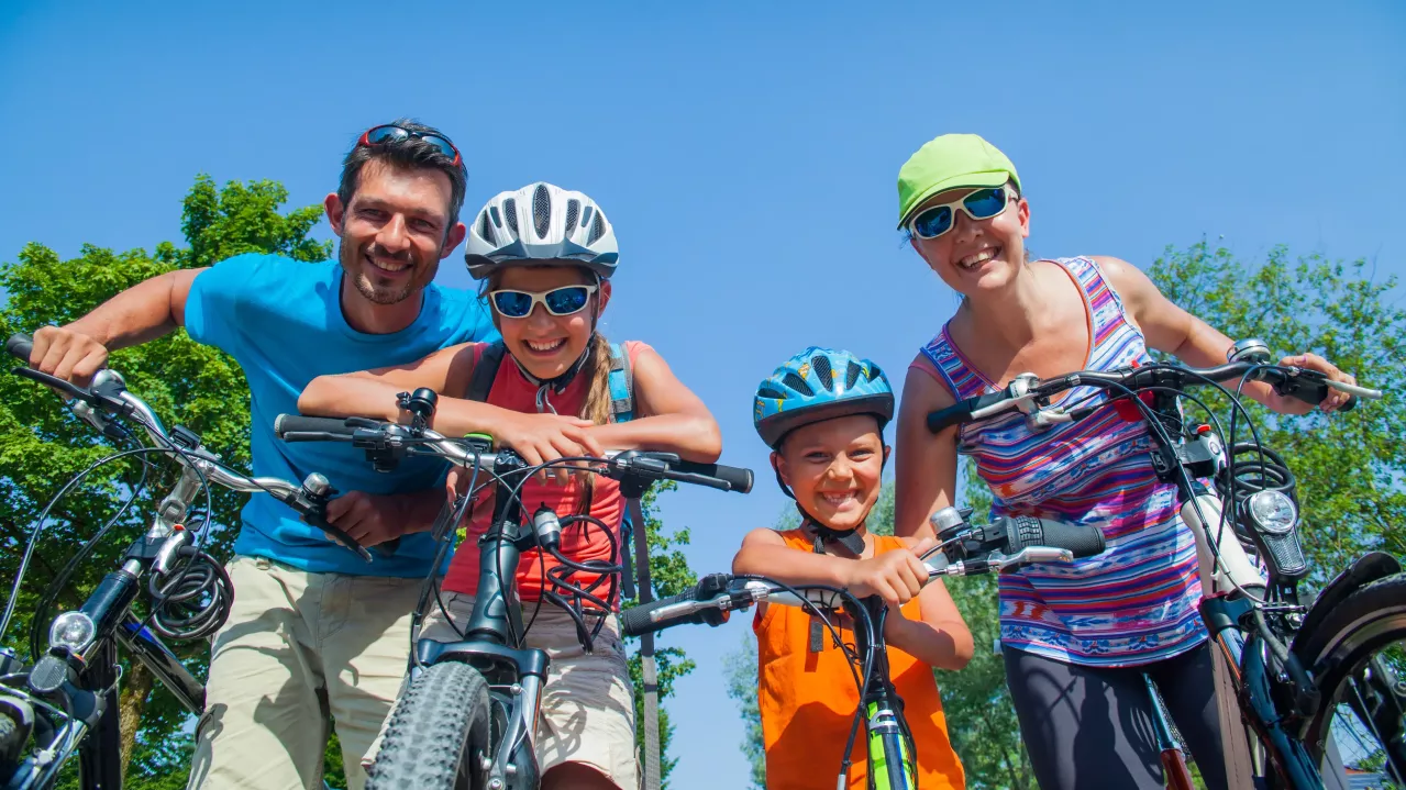 Family of four riding bikes.
