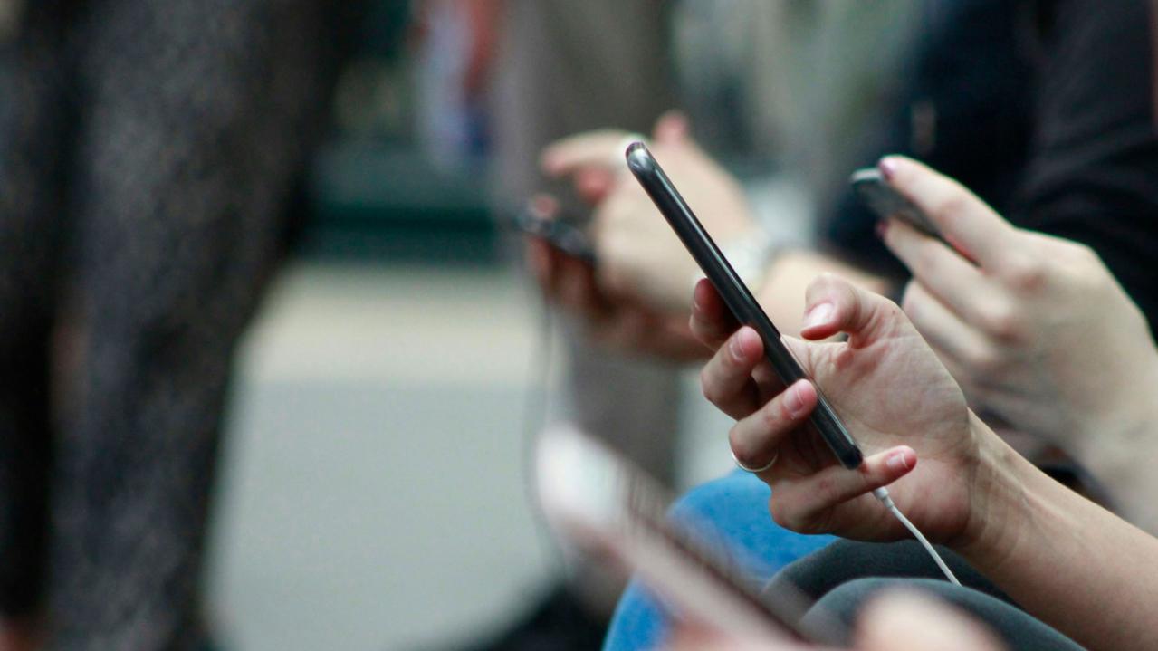 Women holding and interacting with smartphones