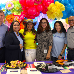 employees smiling at table 