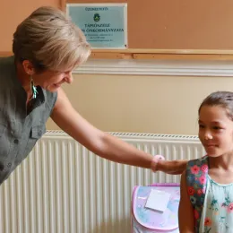 Woman patting child on the back. 