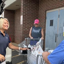 volunteers loading up supplies in vehicle
