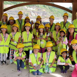 group of young students and Albemarle employees in hardhats