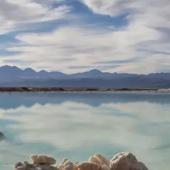 Lagoon with mountains and blue sky with clouds. 