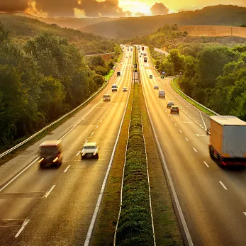 An aerial view of a highway with moving traffic.