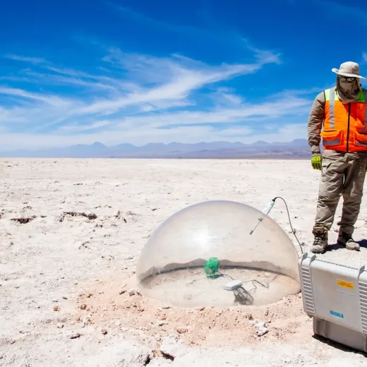 Two men in uniform on the Salar with testing equipment.
