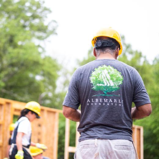 A photo of a woman and a man working with Habitat for Humanity and the Albemarle Foundation