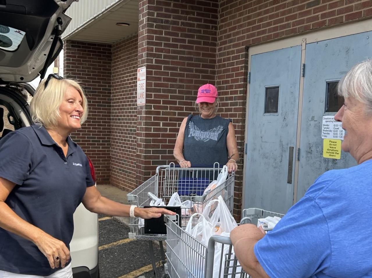 volunteers loading up supplies in vehicle